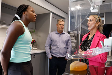 People speaking in a lab setting.