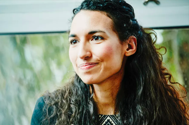 Smiling woman inside in front of a window