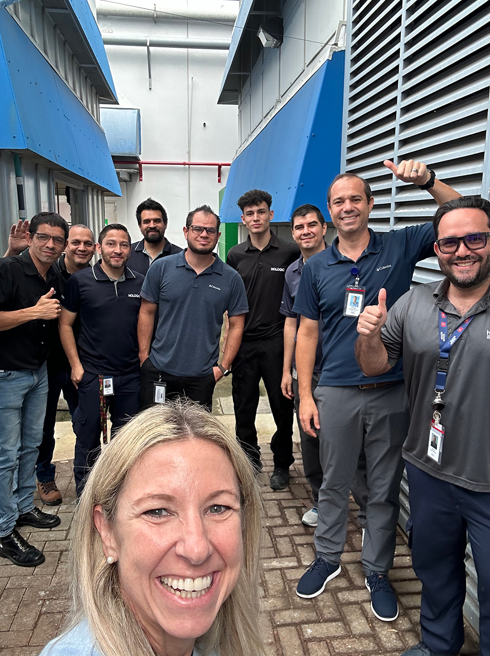 Costa Rica Facilities Team Group of individuals standing together outside an office.