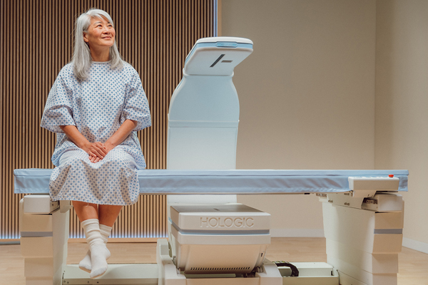 Patient sitting on DXA machine.