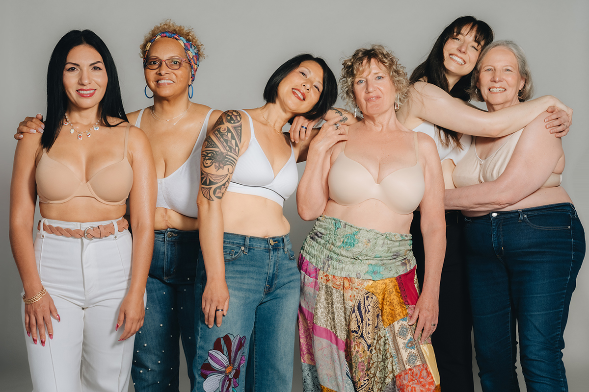 Group of people embrace each other for picture. 