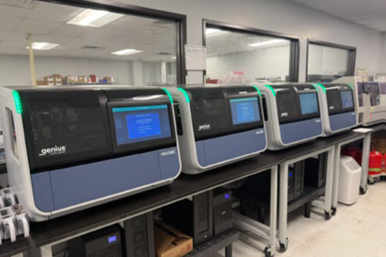 Four medical devices sit side-by-side on a lab bench.