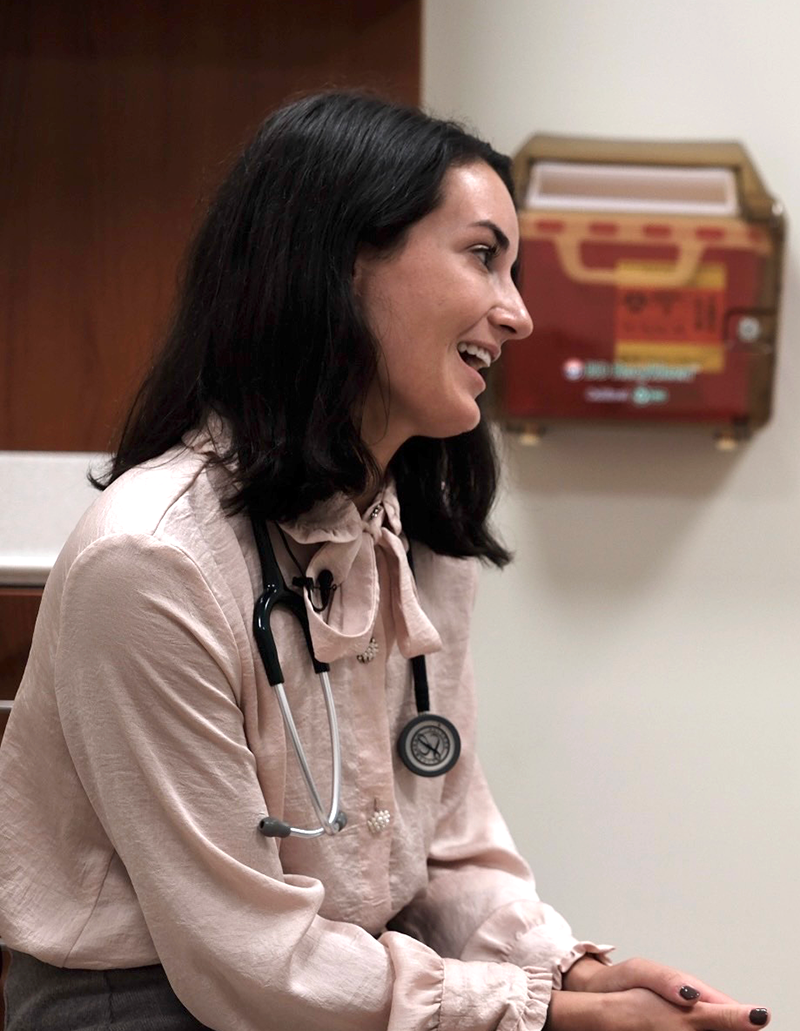 Woman in doctor's office smiling.