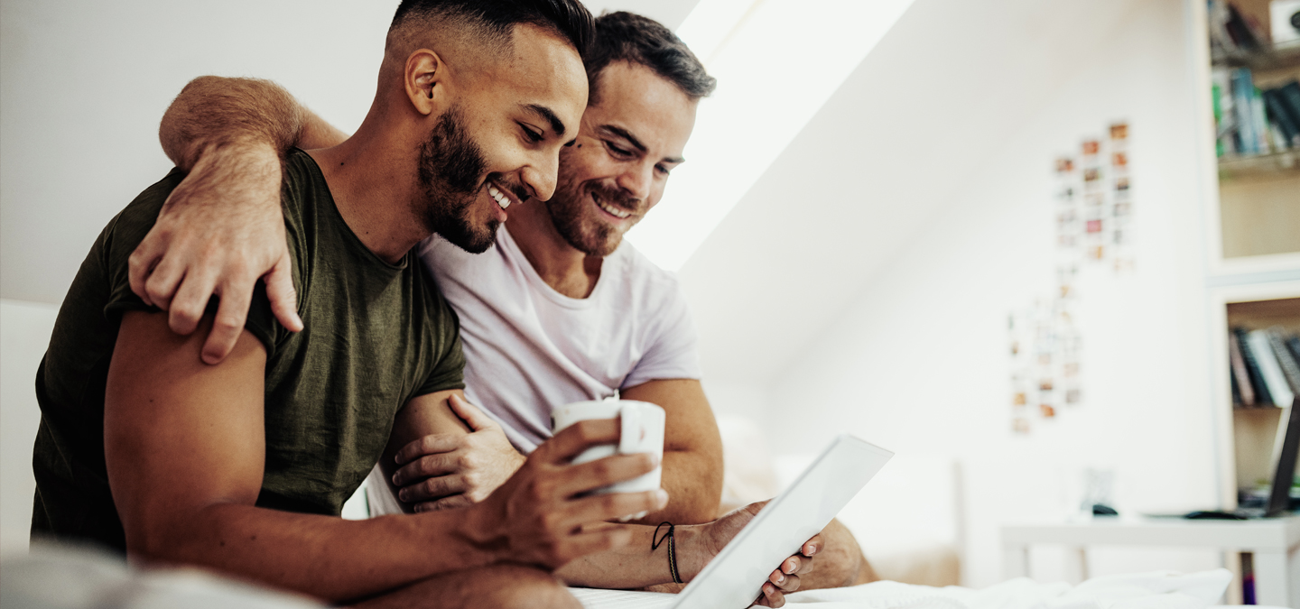 two men reading and smiling