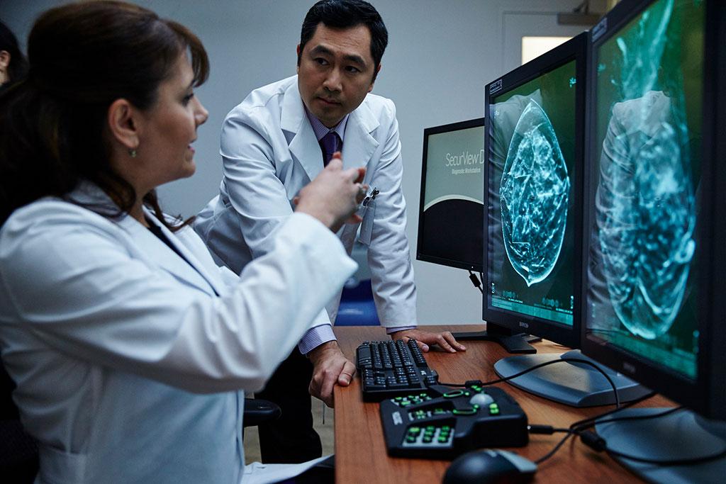 Providers talking and looking at x-rays on monitor