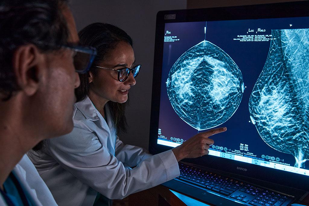 Providers looking at x-rays on monitor