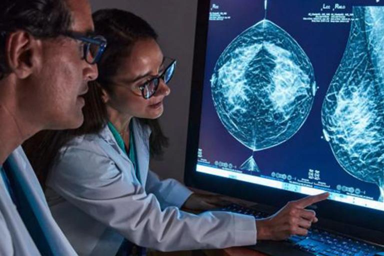 Healthcare professionals pointing on a monitor