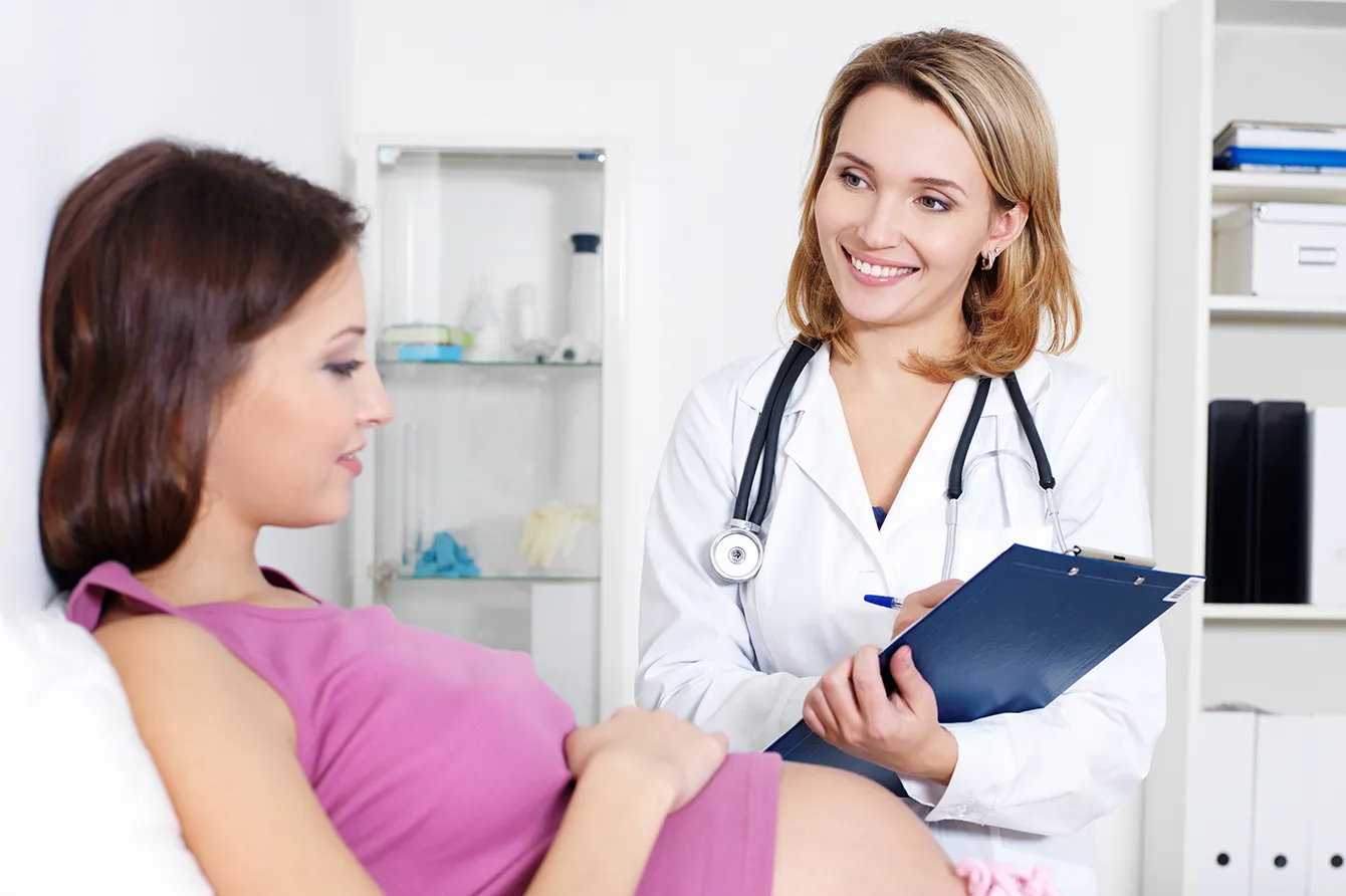 Healthcare provider with patient in clinic room setting.