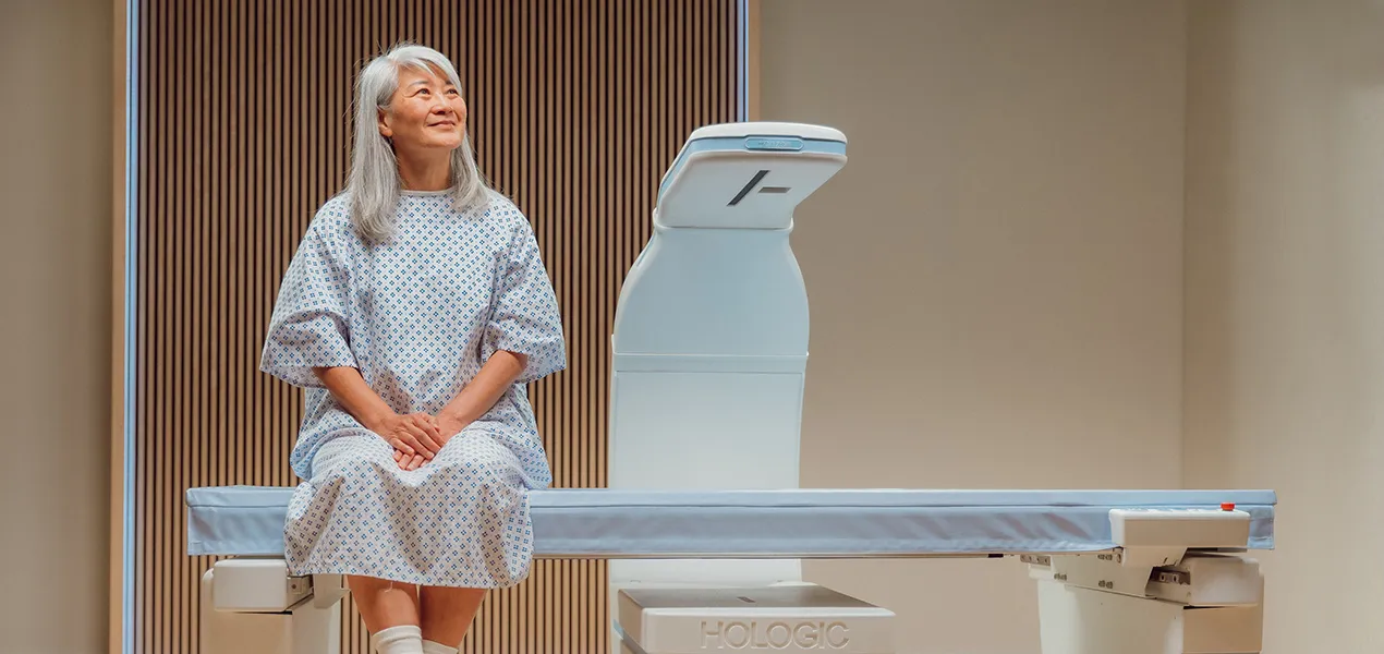 Patient sitting on DXA machine.