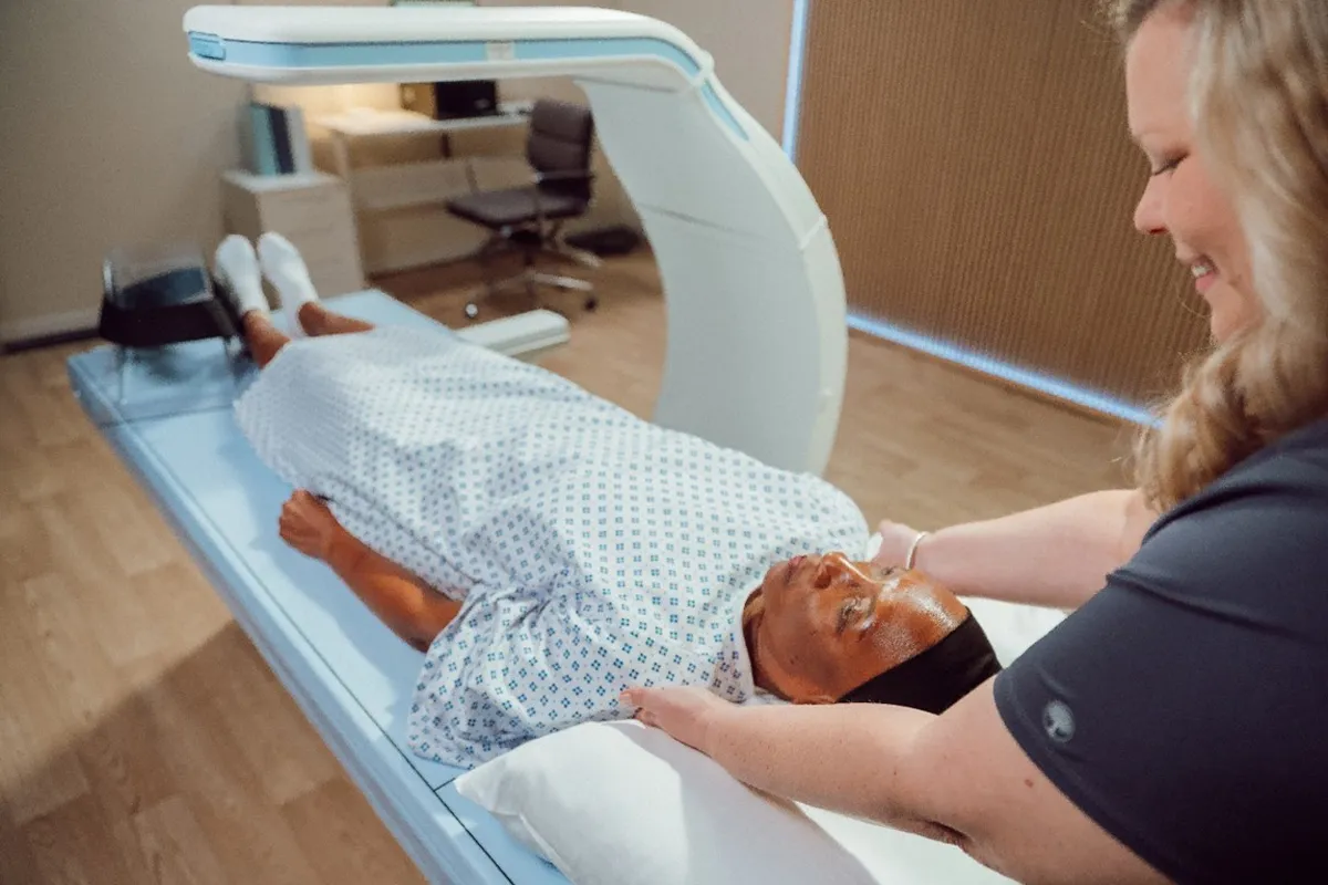 Patient laying on DXA machine.