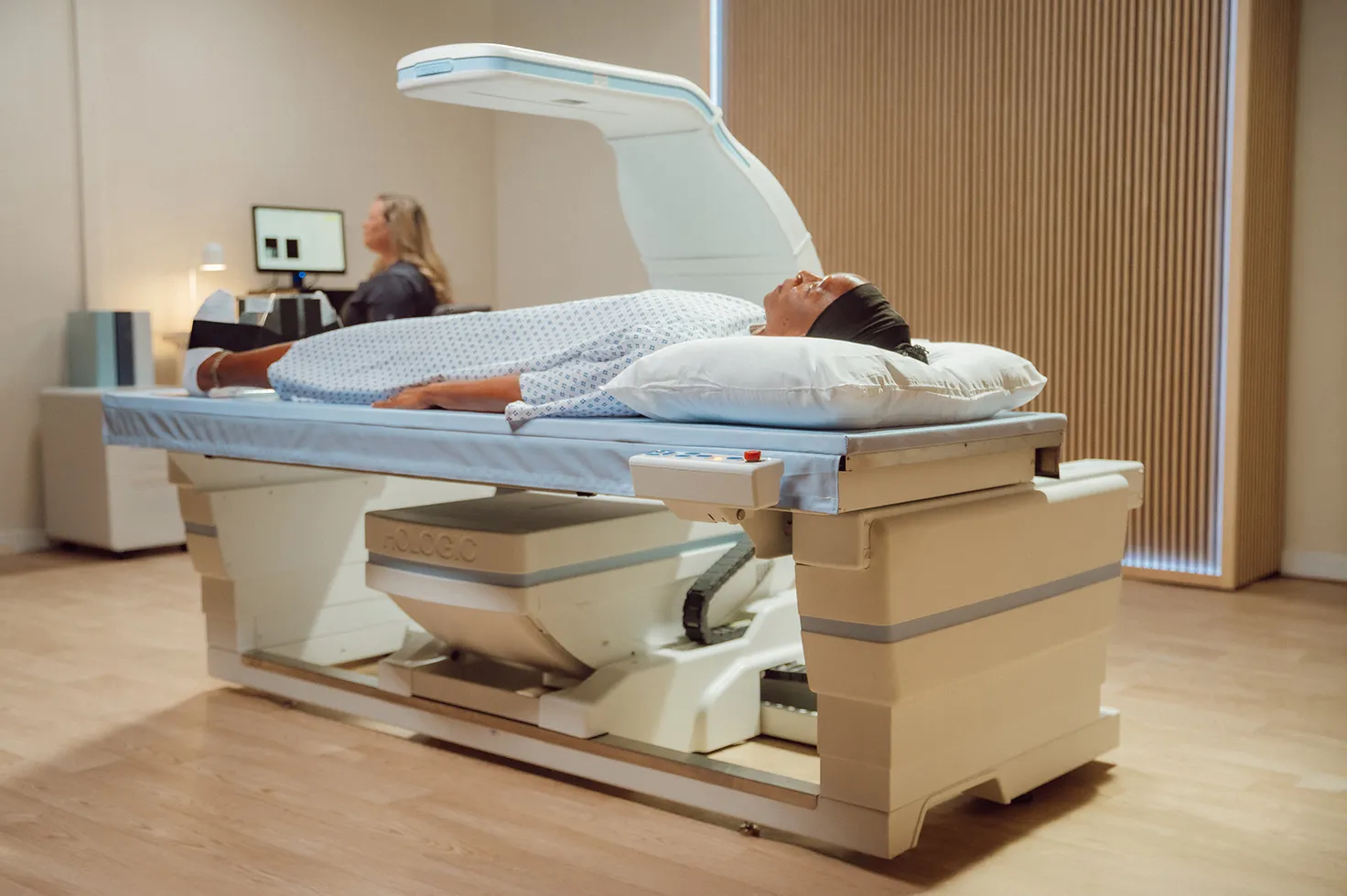 Medical device testing woman on exam table in lab room