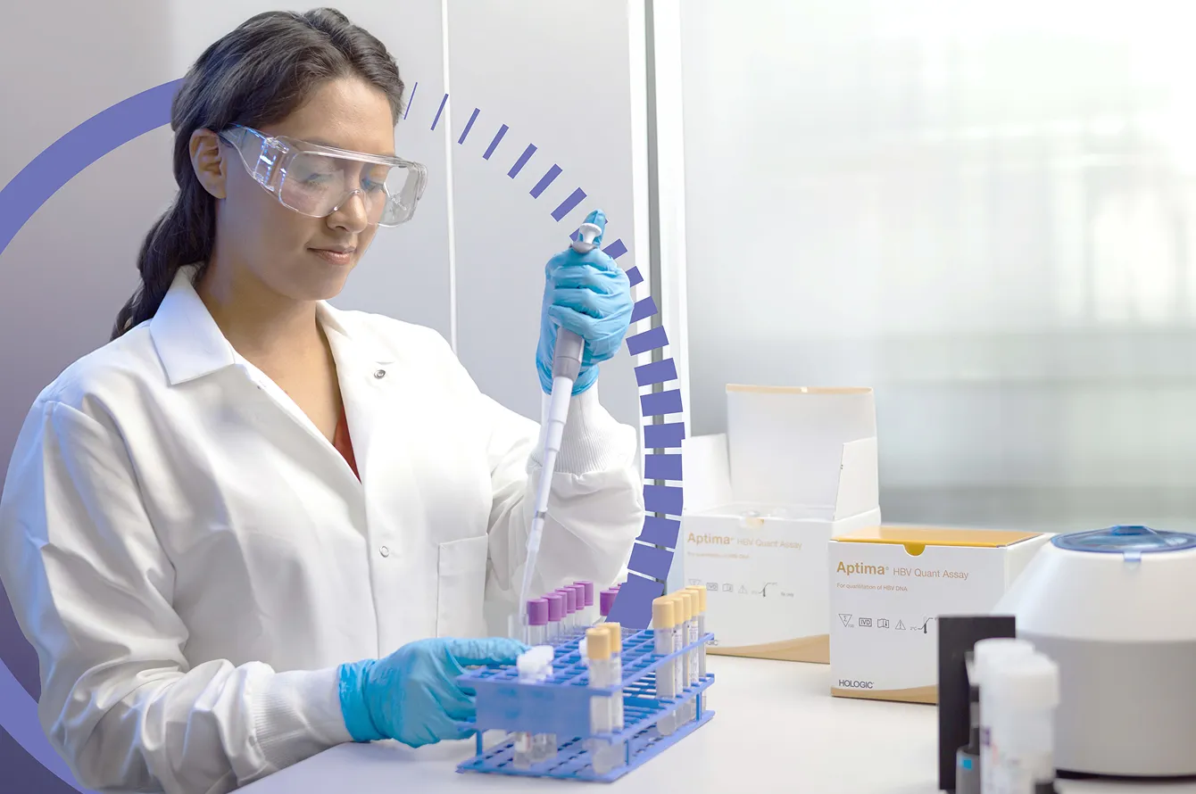 Technician working with vials in a lab setting.