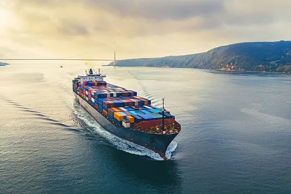 Photo of ship loaded with containers floating across water