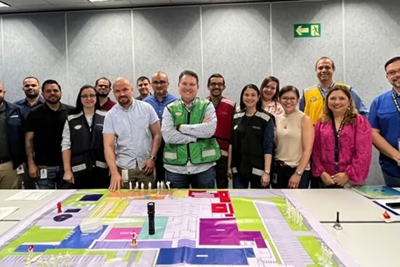 Group photo standing in front of large table