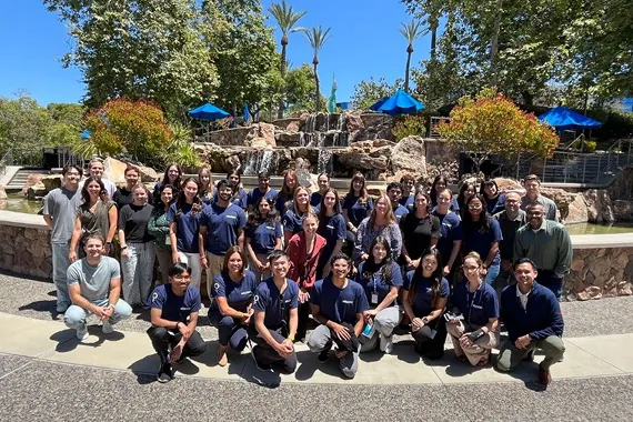 Group photo outside in front of fountain.