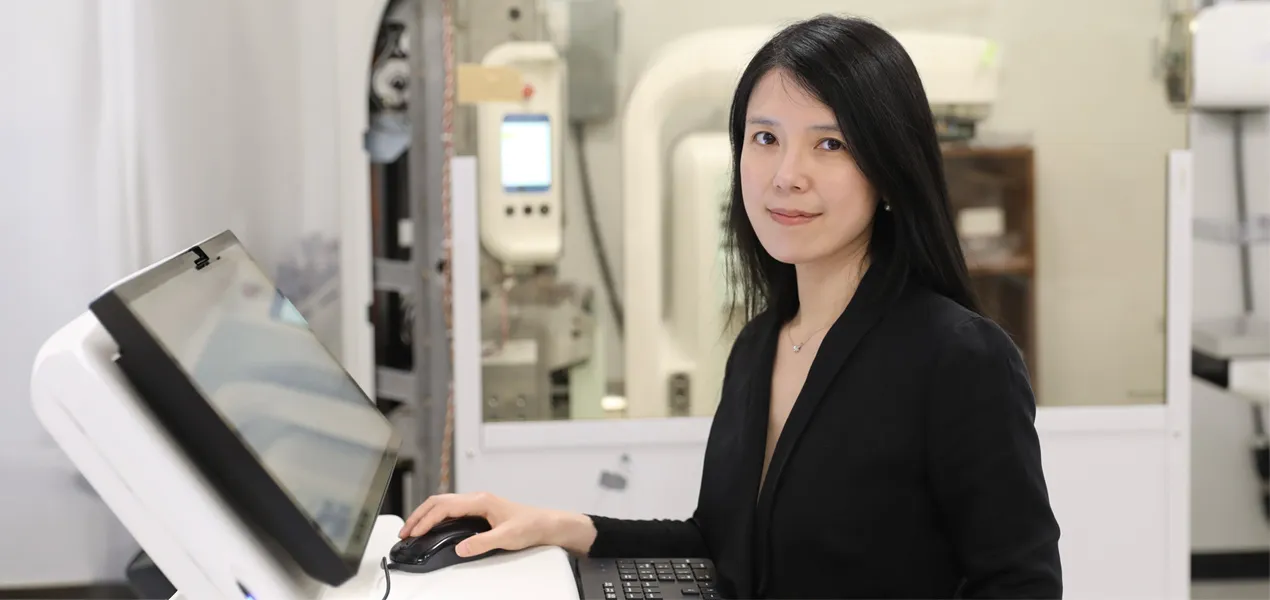 Wei Wang, Ph.D., Hologic scientist, at a mammography imaging workstation