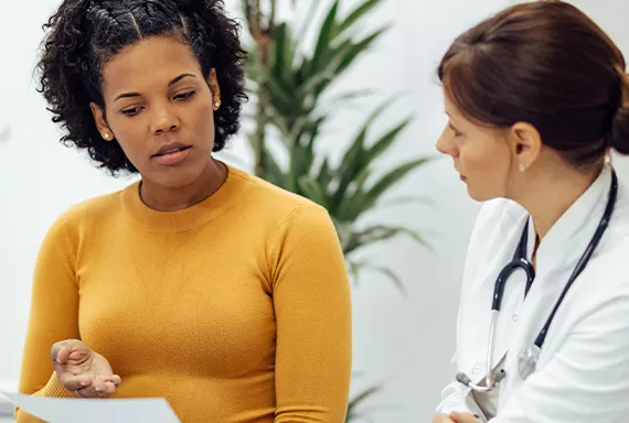 Young woman talking to a doctor