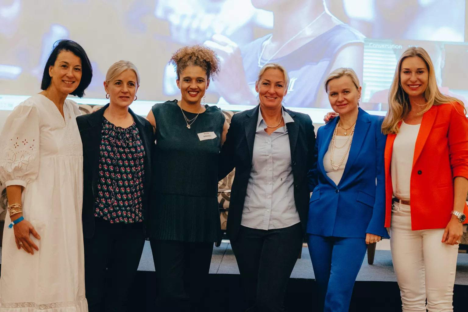 Group photo with Béatrice Lemberg, Hologic’s Senior Director of Surgical Marketing for EMEA and Canada, and other female leaders on a conference stage.