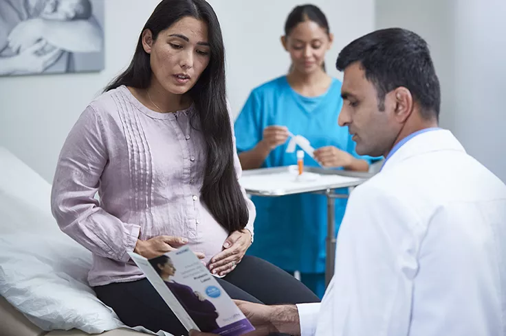 physican and patient talking in lab setting.