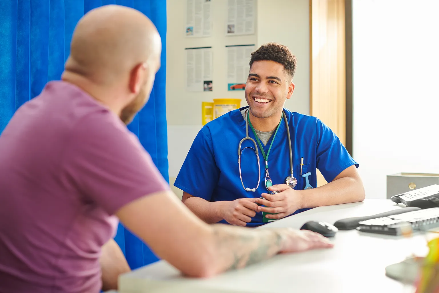 Nurse speaks with patient in office setting