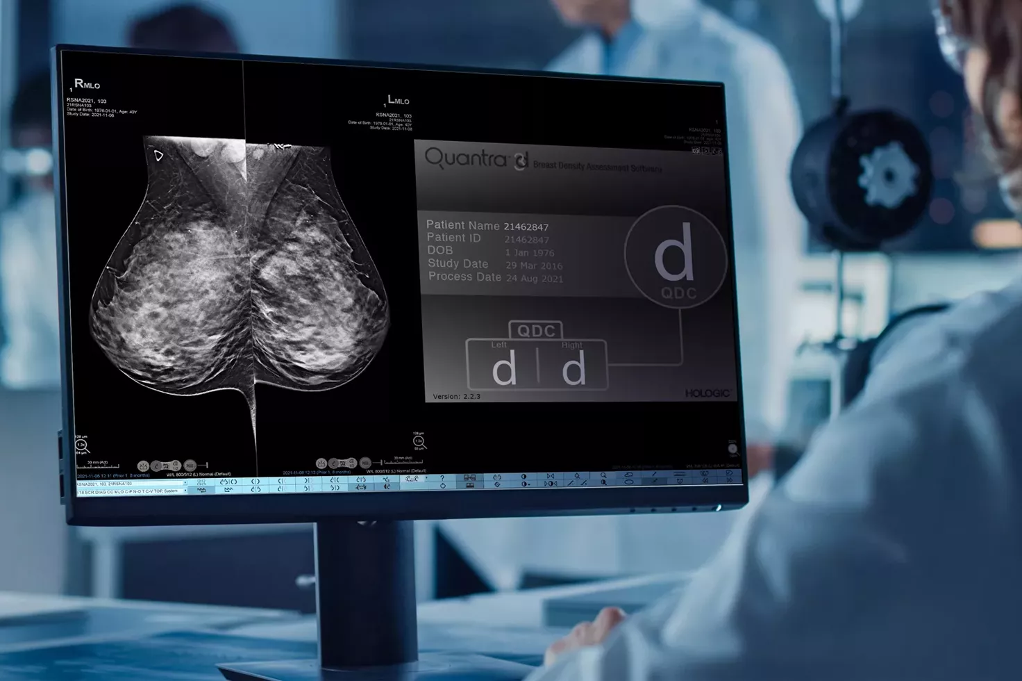 Lab technician viewing monitor with x-ray in lab setting.