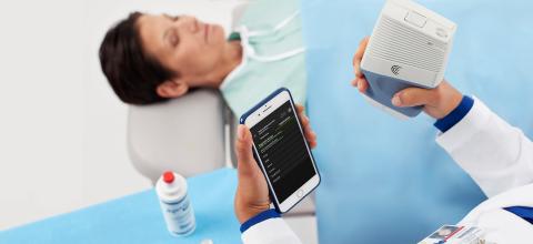 Physician with portable Viera with phone